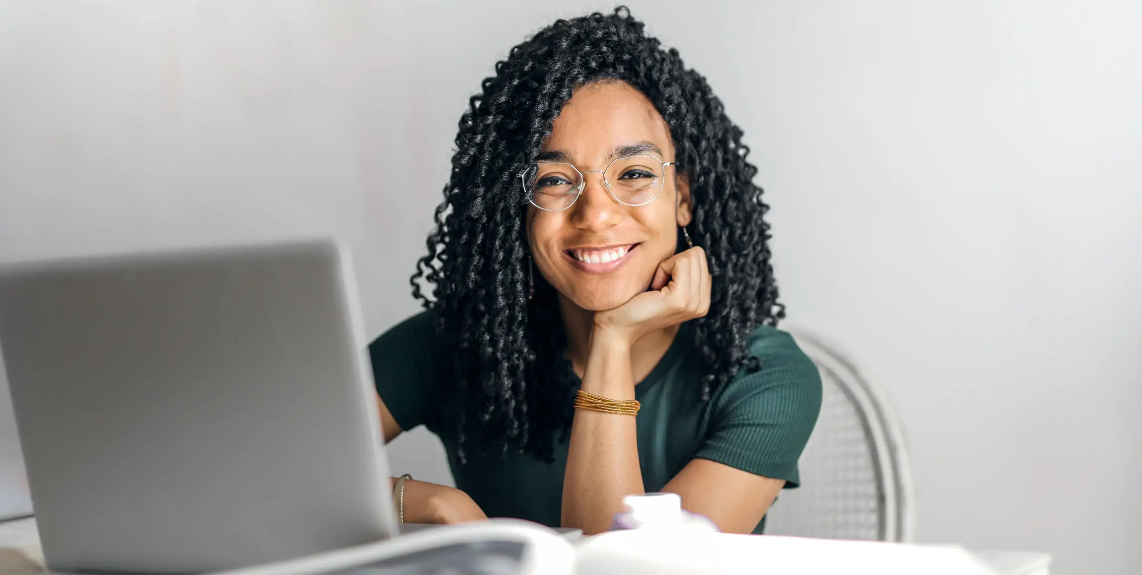 A sourcing professional working on a laptop